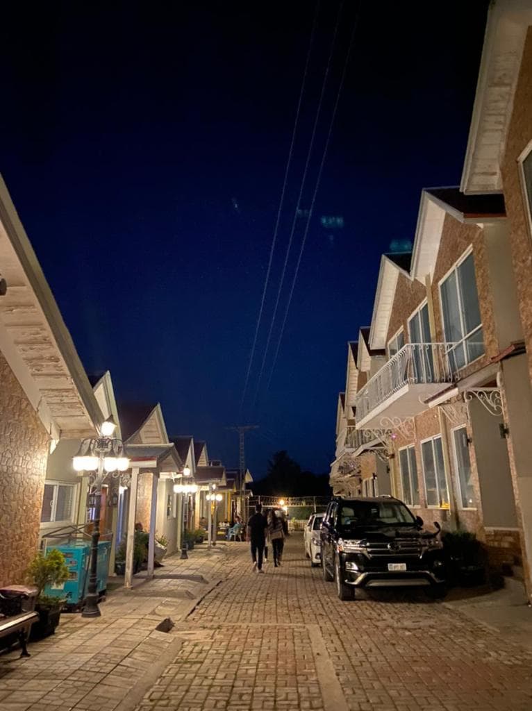 ESTATE — cobblestone lane at night, lanterns